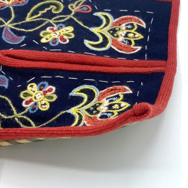 Bind the top edge of the pocket and secure the ends by folding them in under the binding.